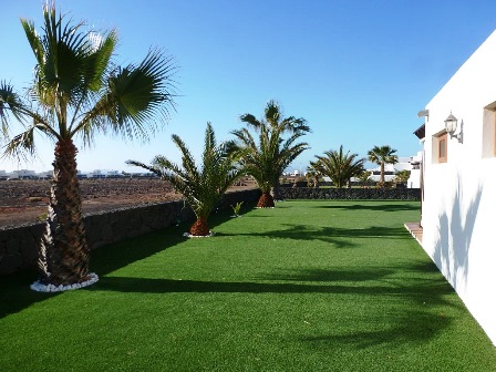 Astroturf to side of Villa Mary