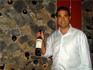 Villa Manager, Pedro Wine proudly showing off vintage wine from the basements wine cellar